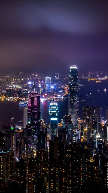 Night view of Victoria Peak cityscape with illuminated skyscrapers and vibrant lights