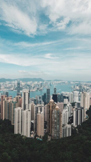 A stunning view of Victoria Peak showing skyscrapers and the cityscape under a blue sky