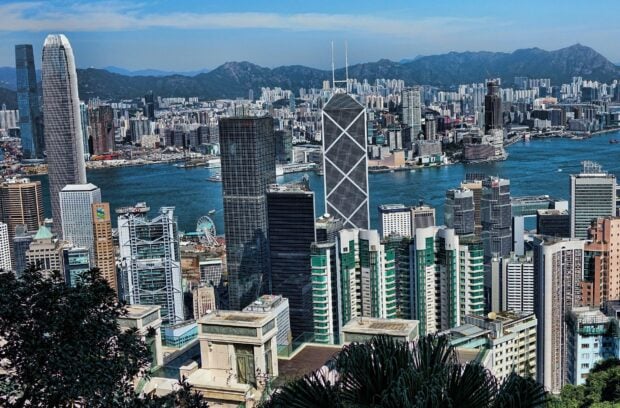 A panoramic view of Victoria Peak cityscape with skyscrapers and harbor in HD quality