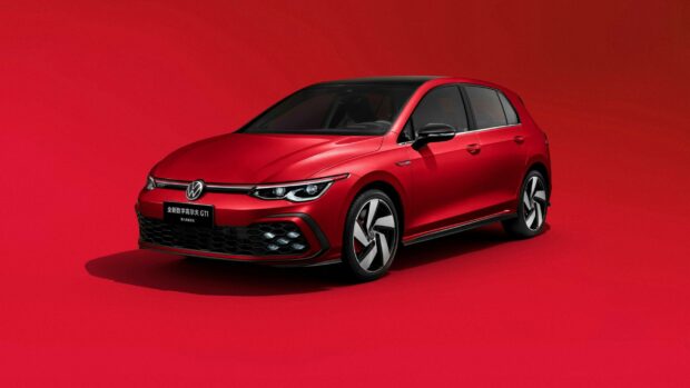 A red Volkswagen GTI car showcased on a red background with a sleek design