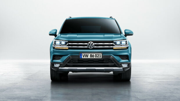 Front view of a sleek Volkswagen vehicle with modern headlights and a clear license plate VW 86 021