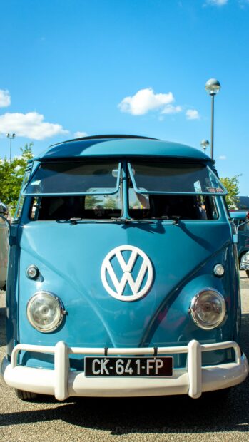 Blue Volkswagen classic van with front logo and license plate on a sunny day