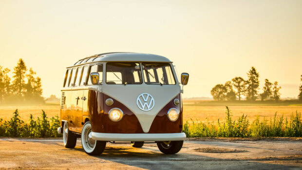 Vintage Volkswagen van parked on rural road during golden hour light