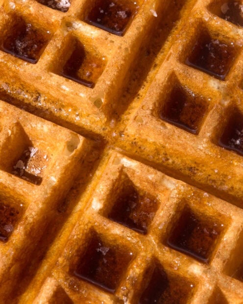 Close up of crispy waffle with syrup filling the squares