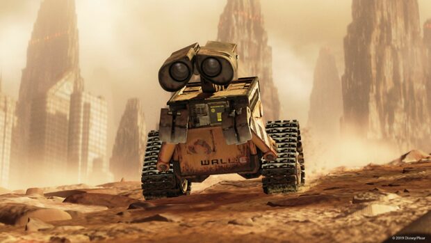 A Walle robot exploring a desolate futuristic cityscape with towering ruined buildings