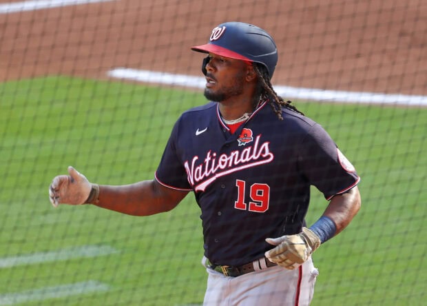 A Washington Nationals player wearing a helmet and jersey number 19 on the baseball field