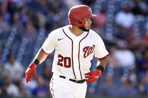 A Washington Nationals player wearing number 20 running on the baseball field in full uniform