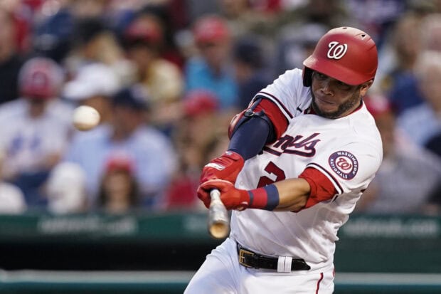 A Washington Nationals player is hitting a baseball during a professional game