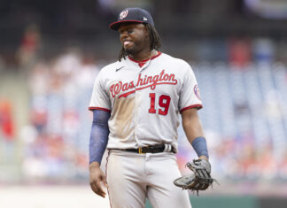 A Washington baseball player wearing number 19 standing on the field during a game