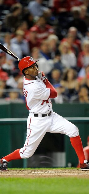 Baseball player in Washington Nationals uniform swinging the bat during a game