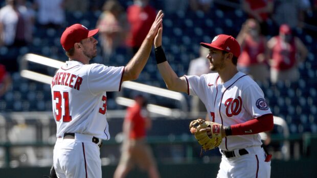 Washington Nationals players celebrating with a high five during a baseball game