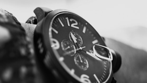 Close up of watch chronograph on wrist with detailed dial and buttons