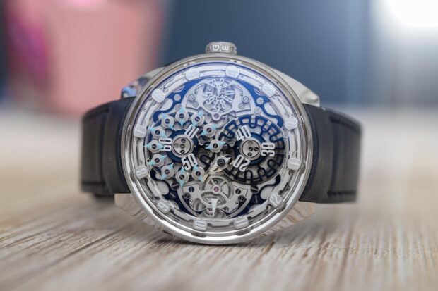 Close up of intricate watch mechanism showing detailed gears and hands