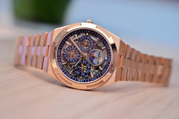 A luxury skeleton mechanical watch with a rose gold bracelet and detailed dial complications
