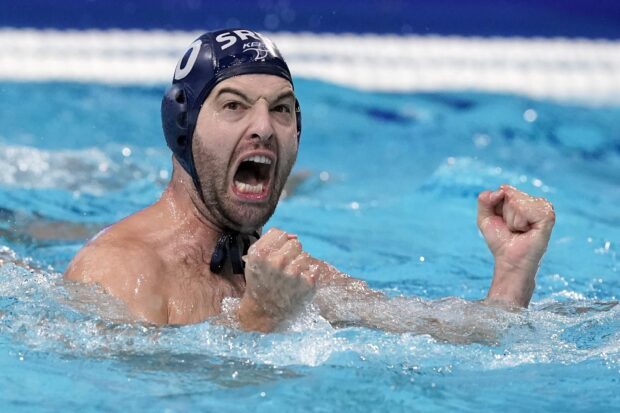 Male water polo player showing excitement during the game in the pool