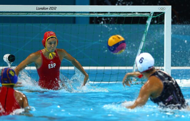 Female water polo player from Spain defending goal during match