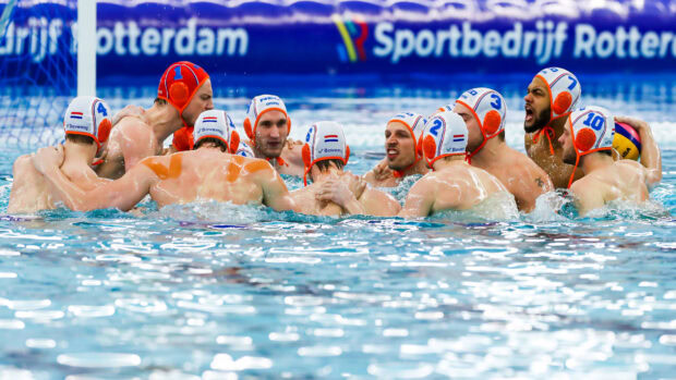 Water polo team huddling together in the pool before a match