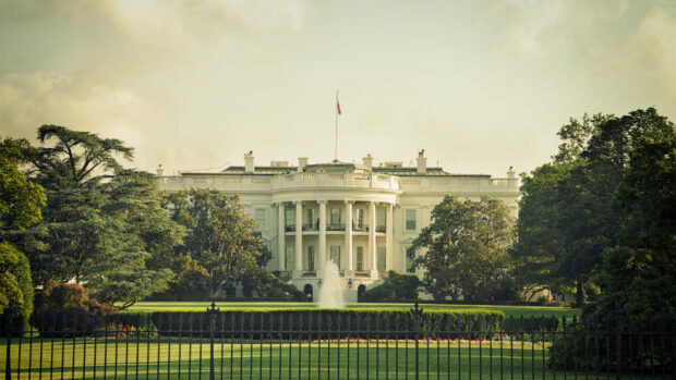 The White House surrounded by trees and a water fountain on a clear day