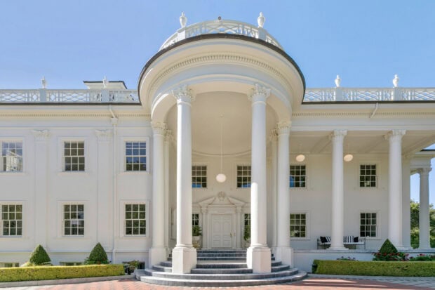 The White House with tall columns and clear blue sky in high definition