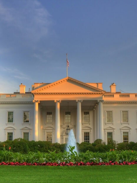 White House with fountain and garden in front during sunset HDR scene