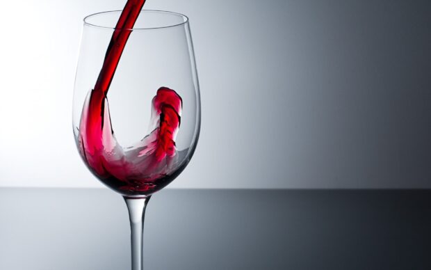 Red wine swirling inside a wineglass captured in high detail liquid motion