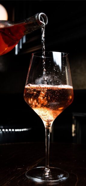 Pouring sparkling wineglass with bubbles in a close up view