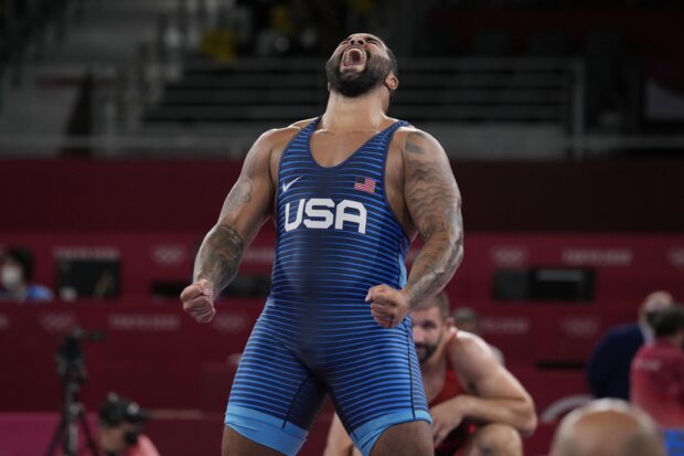 Wrestler from USA celebrating victory on wrestling mat