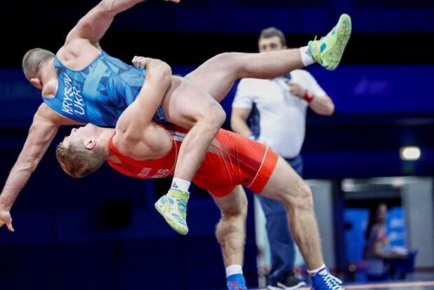 A wrestling athlete from Ukraine lifts his opponent during a wrestling match