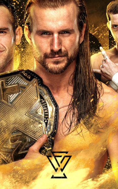 A professional wrestler holding a championship belt with long hair and a focused expression