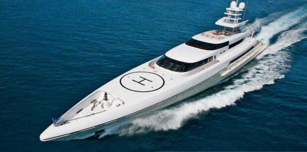 Luxury yacht cruising on clear blue ocean water