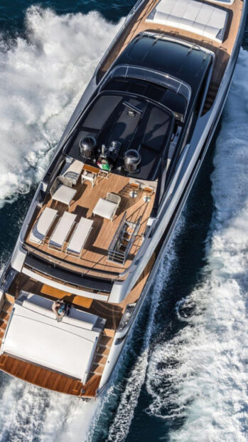 Luxury yacht deck with wooden furniture cruising on the ocean