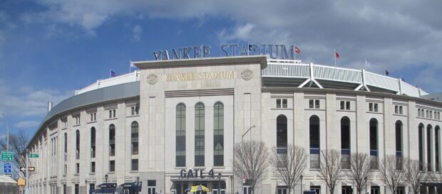 Exterior view of Yankee Stadium with Gate 4 and surrounding architecture on a clear day