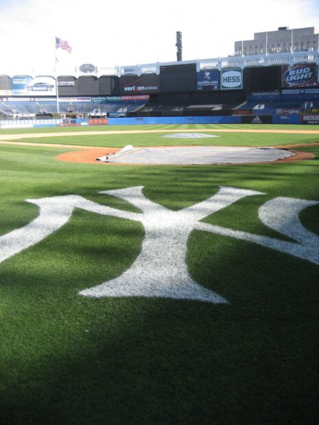 The field inside Yankee Stadium with a close up of the NY logo on the grass