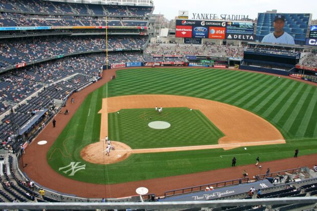 A panoramic view of Yankee Stadium field with players warming up before the game
