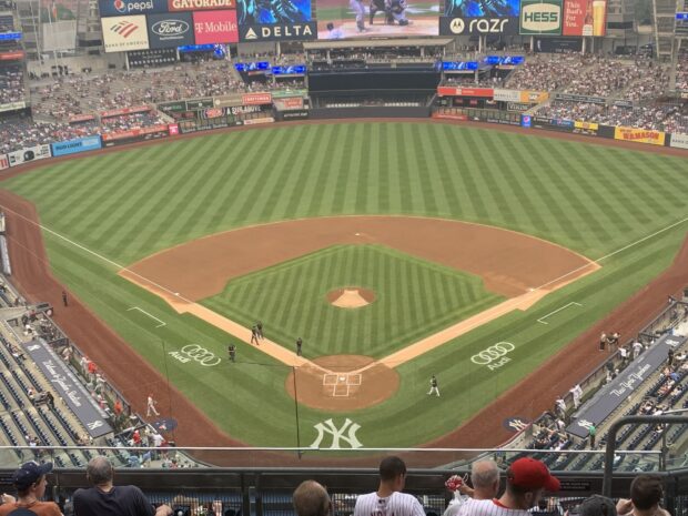 A panoramic view of Yankee Stadium baseball field with spectators and players on the field
