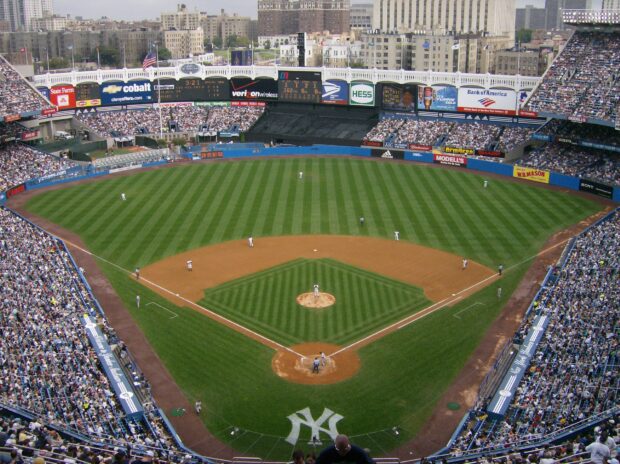 Aerial view of Yankee Stadium with players on the field and a large crowd in the stands