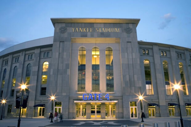 The iconic Yankee Stadium gate with illuminated windows and gate 4 sign at dusk