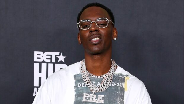 Young Dolph wearing glasses and diamond chains at a BET Hip Hop Awards event