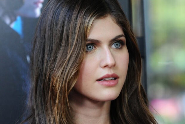 Alexandra Daddario with blue eyes and flowing hair looking thoughtfully ahead