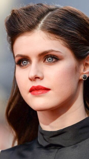 Alexandra Daddario with striking blue eyes and red lipstick wearing black top