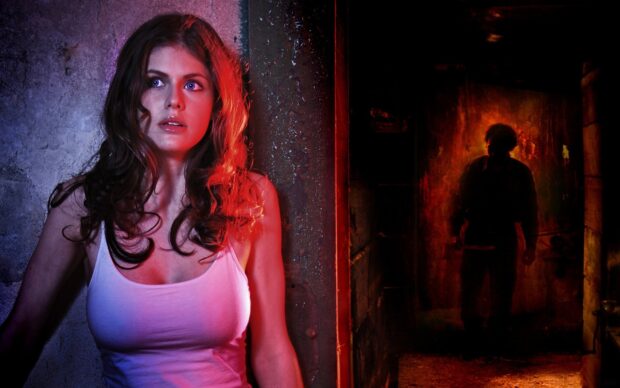 Alexandra Daddario in a thriller scene looking scared while a shadowy figure approaches in the background