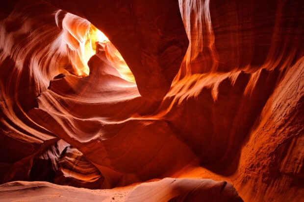 The intricate rock formations of Antelope Canyon with warm glowing light