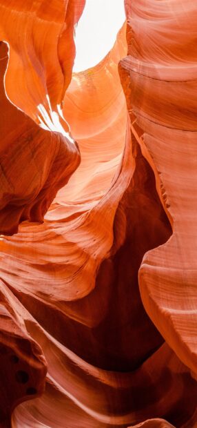 Natural stone formations in Antelope Canyon displaying smooth curves and warm light