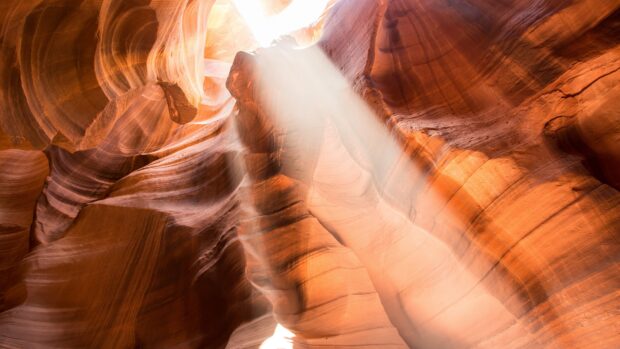 Sunlight beams illuminating the natural rock formations in Antelope Canyon