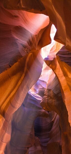 Natural rock formations in Antelope Canyon with sunlight beams illuminating the canyon walls