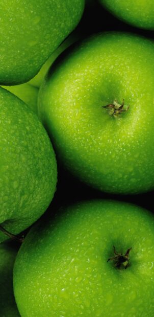 Close up of fresh green apple fruit with water droplets on skin