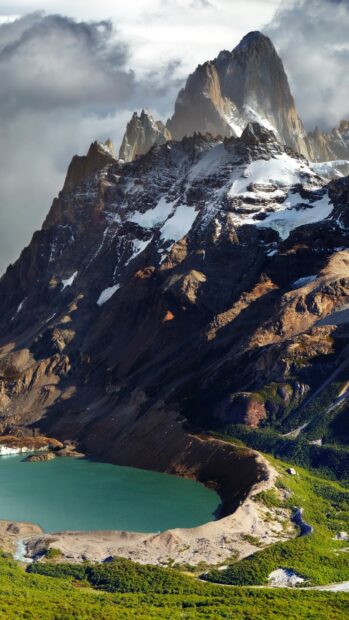 Snow capped peaks and turquoise lake in Argentina mountain landscape with clear sky