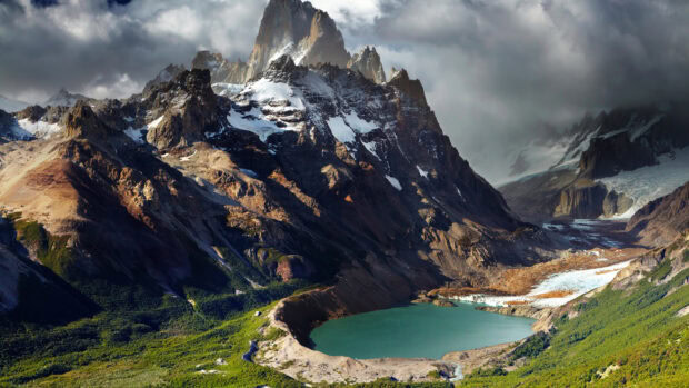 Majestic Argentina mountain landscape with a turquoise lake and rugged peaks covered in snow
