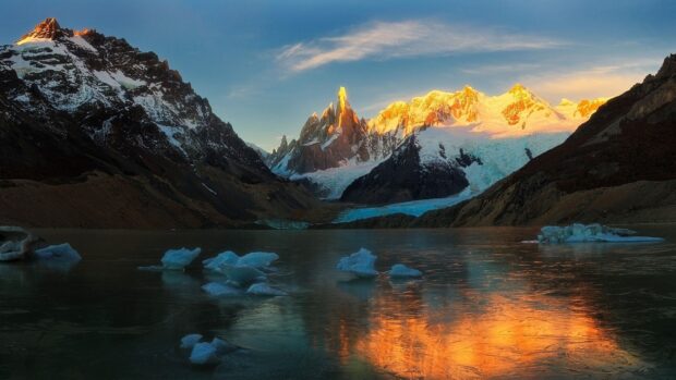 Snowy mountains and glacial lake in Argentina glowing at sunset with clear sky