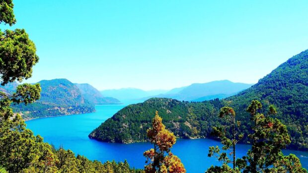 A scenic Argentina landscape with lush forested mountains and a clear blue lake